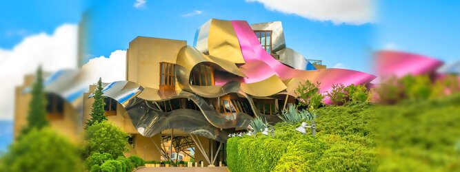 Trip Kreuzfahrten Reisetipps - Marqués de Riscal Design Hotel, Bilbao, Elciego, Spanien. Fantastisch galaktisch, unverkennbar ein Werk von Frank O. Gehry. Inmitten idyllischer Weinberge in der Rioja Region des Baskenlandes, bezaubert das schimmernde Bauobjekt mit einer Struktur bunter, edel glänzender verflochtener Metallbänder. Glanz im Baskenland - Es muss etwas ganz Besonderes sein. Emotional, zukunftsweisend, einzigartig. Denn in dieser Region, etwa 133 km südlich von Bilbao, sind Weingüter normalerweise nicht für die Öffentlichkeit zugänglich.